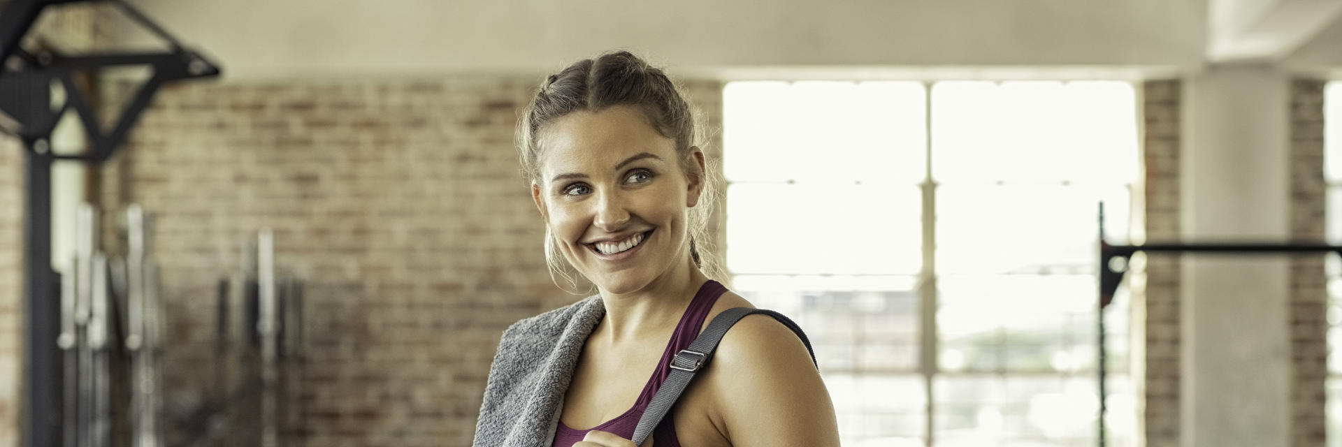 Athlete woman in sports clothes before work out at the gym.