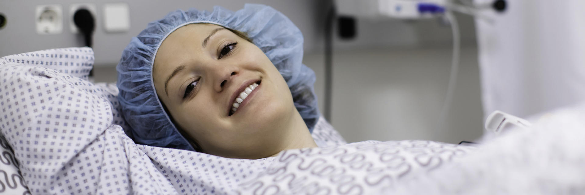 Relaxed woman in hospital bed after orthopedic surgical procedure.