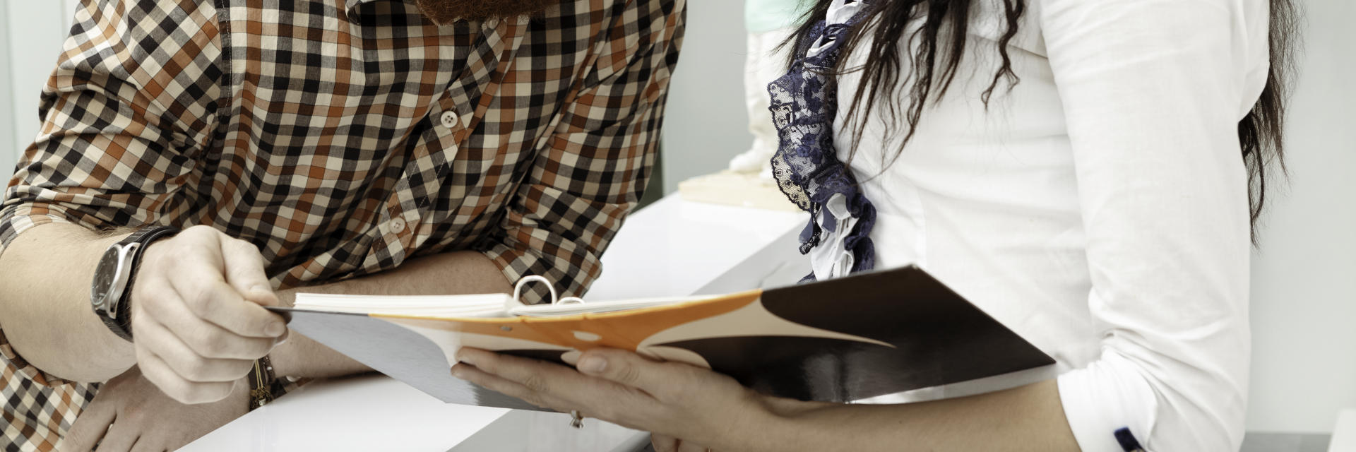 A man and a woman revising documents.