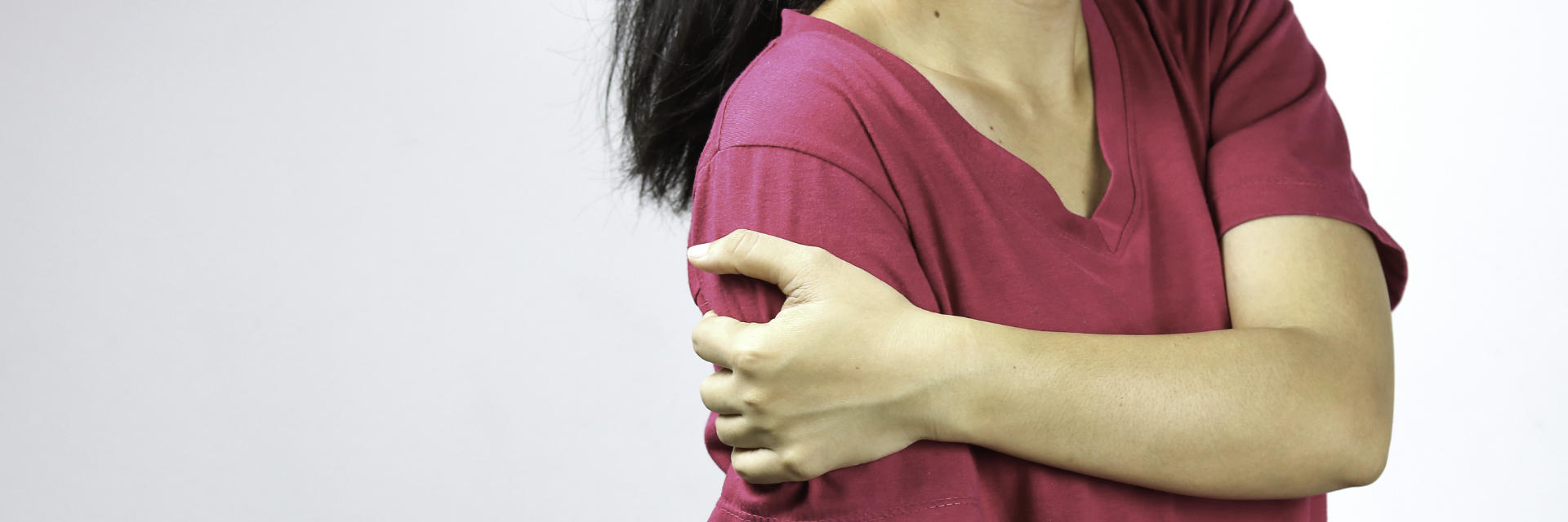 Woman suffering from shoulder pain due to bursitis.