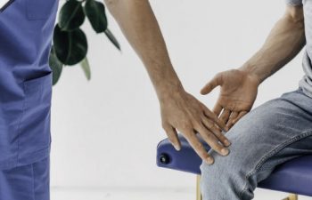 An orthopedic doctor examining a patient with knee pain.