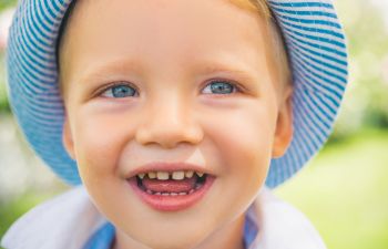 Cute Little Boy With Blue Eyes Closeup. Portrait Of Happy Kid Ou