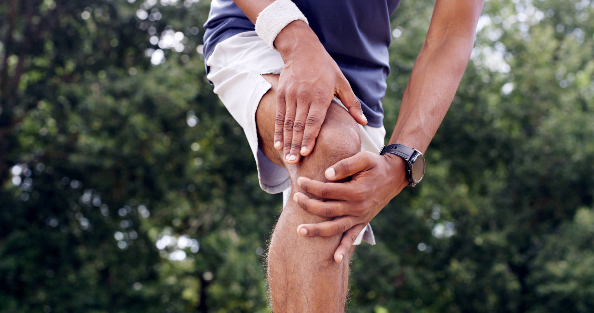 Nature, fitness and hands of man with knee pain, injury or accident for workout in morning. Inflammation, sports and athlete with muscle sprain or torn ligament in leg outdoor in park for exercise.