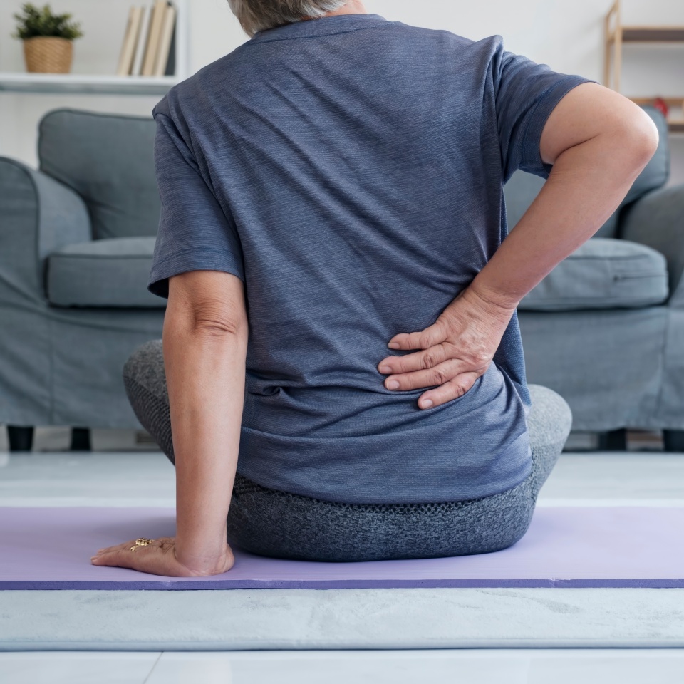 Elderly woman touching her aching hip. Upset mature old woman touching back feel hurt osteoarthritis kidney spine ache sore muscles, sad senior lady suffer from lower lumbar pain.