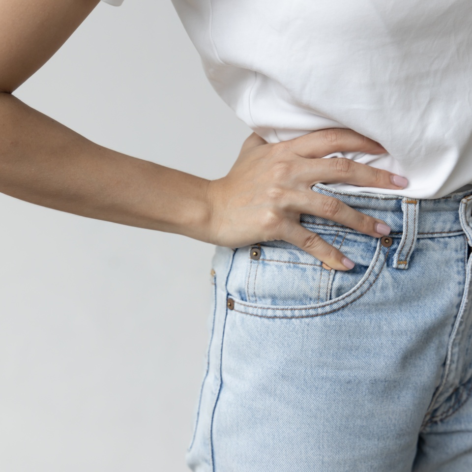 Asian woman suffering from pelvic pain, hip muscle stiffness