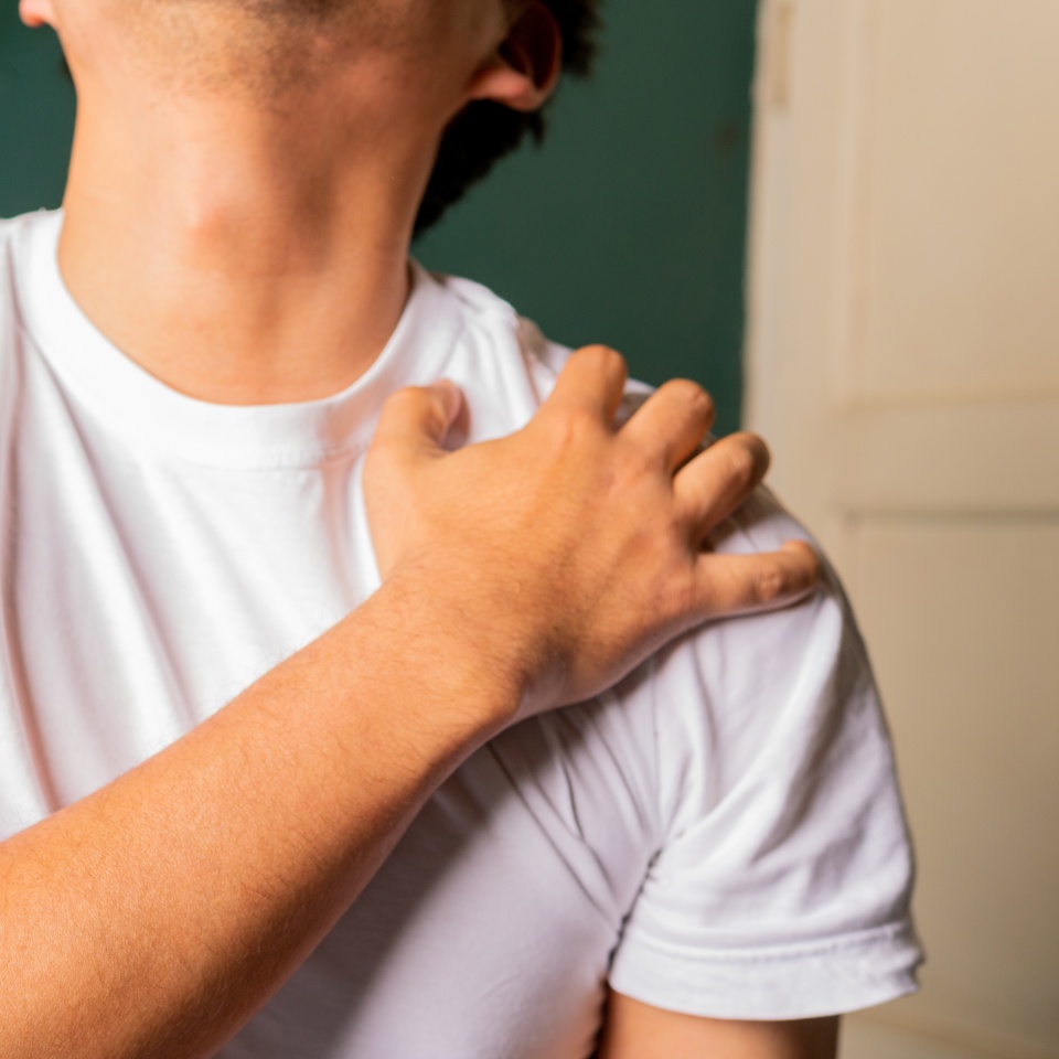 A man feeling pain in the shoulder, Tendonitis, injury, stress