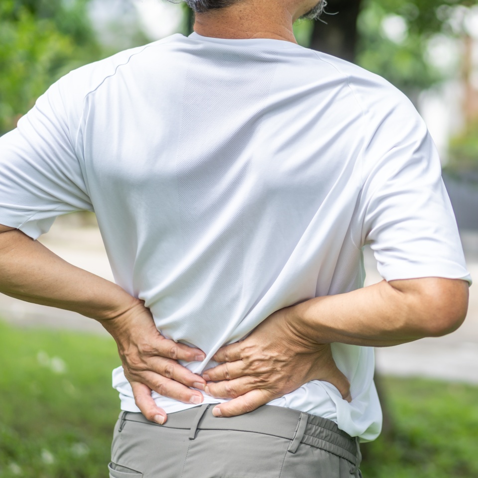 Sick unhappy senior adult elderly man touching her muscle injury Lower back suffering from muscles back pain at home.physical injury and healthcare problem