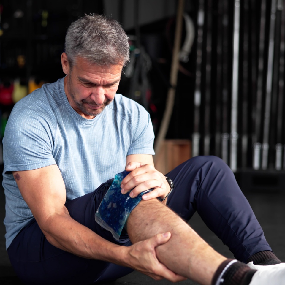 Ice Pack On Knee Leg Joint. Gym Injury
