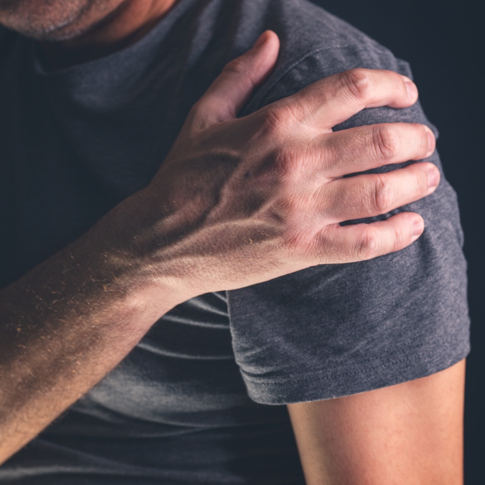Aching frozen shoulder pain as symptom of rotator cuff tendinitis, adult caucasian male suffering from chronic bursitis, selective focus