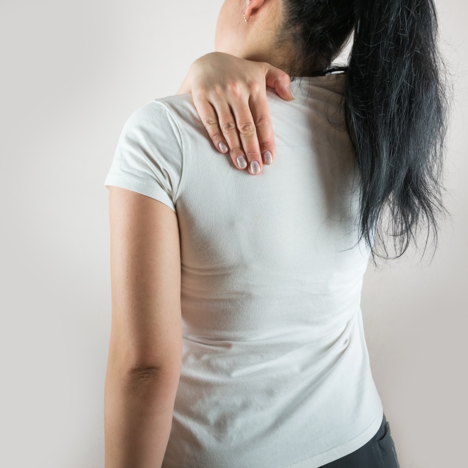 Shoulder blade pain. Woman suffering from back pain. Spine diseases, injuries, arthritis, scoliosis, pinched nerve. Healthcare concept.