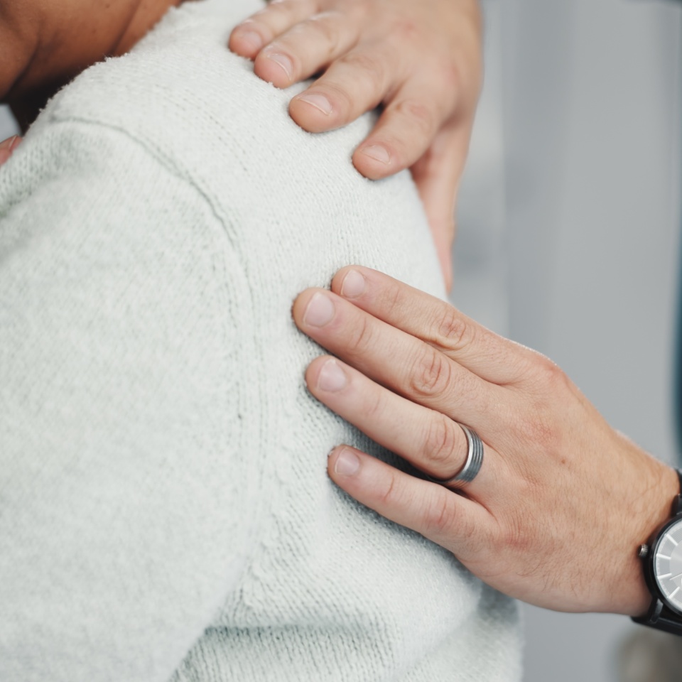 Hands, medical or shoulder pain with patient and physiotherapist in clinic for diagnosis. Appointment, checkup or healthcare with chiropractor and person in office for consulting or rehabilitation