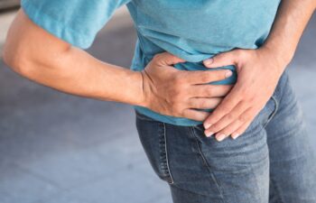 injured man suffering from pelvic pain or hip joint injury